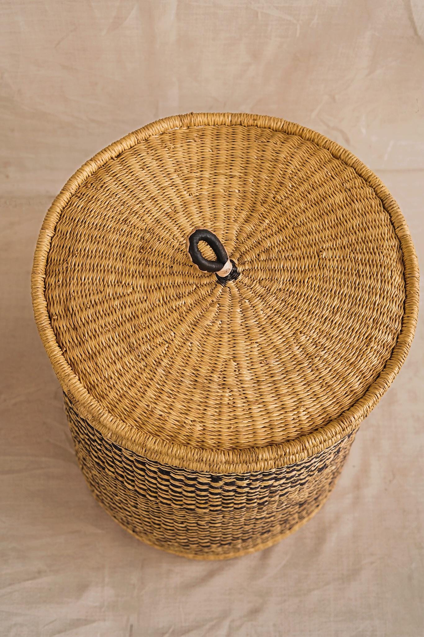Wicker basket with a lid on a neutral background