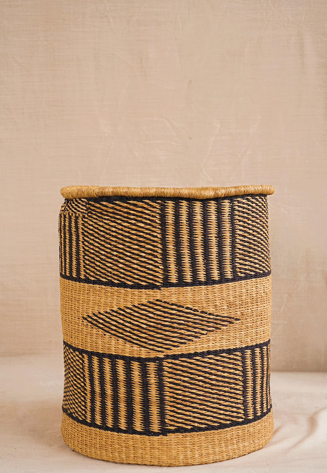 Woven basket with black patterns on a neutral background