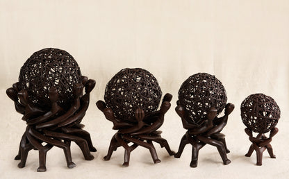 Wooden sculpture of interlocking figures on a beige background