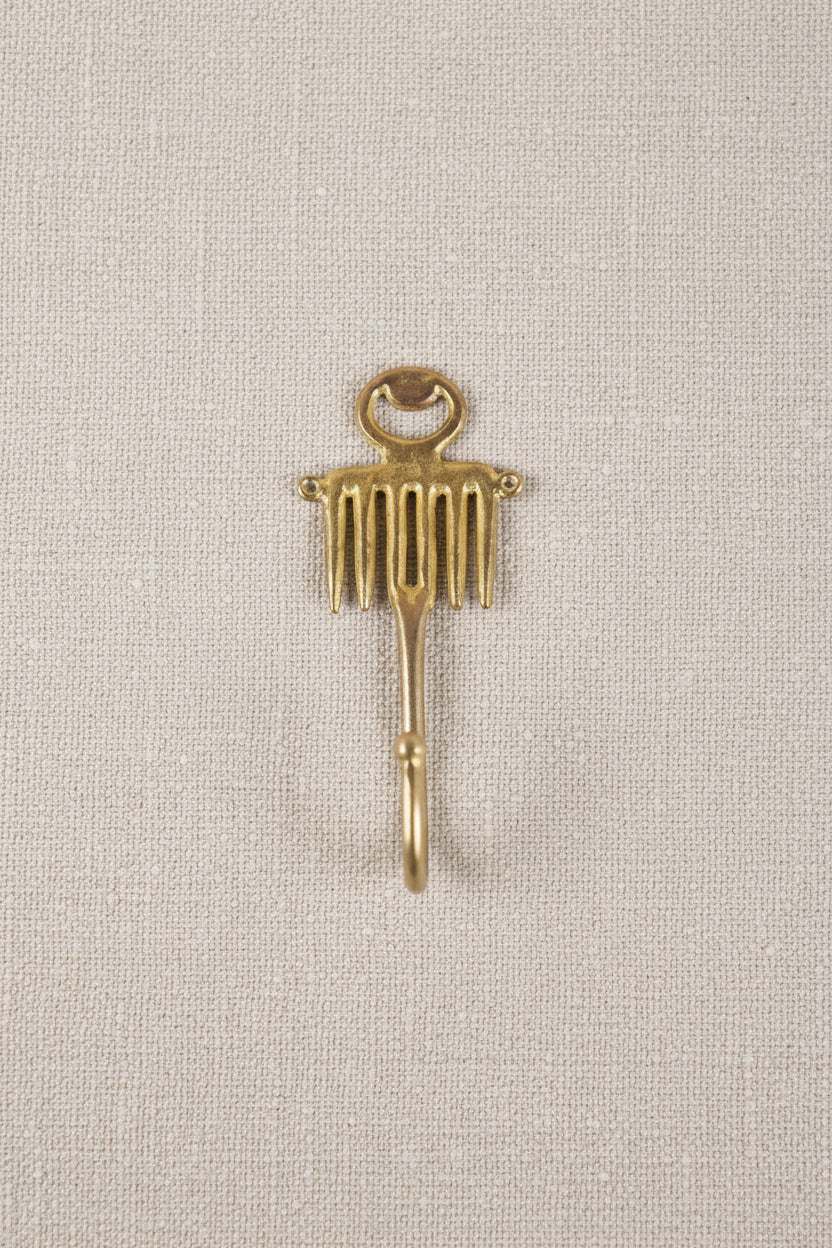 brass decorative hook on a white background