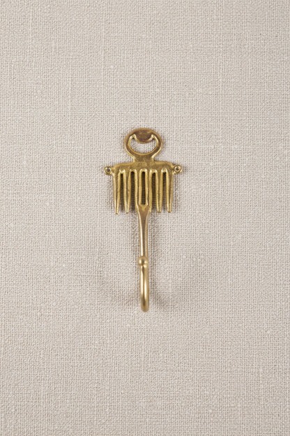 brass decorative hook on a white background