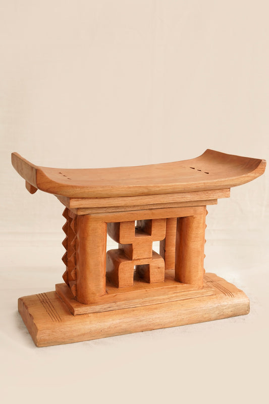 Wooden stool with a traditional design on a beige background