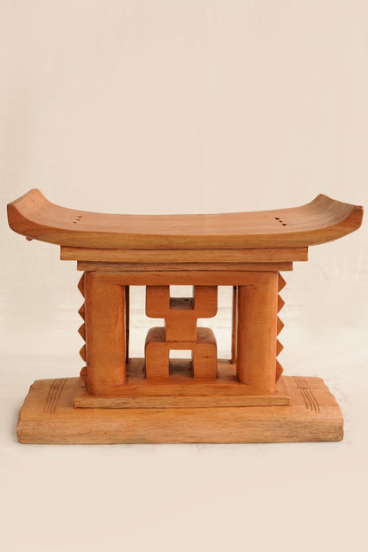 Wooden stool with a geometric design on a beige background