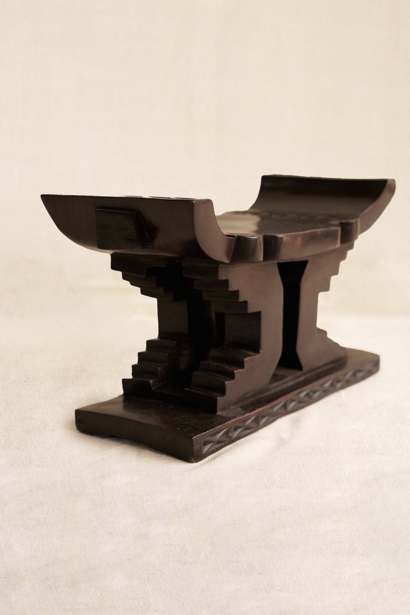 Decorative black Ashanti stool  on a beige background