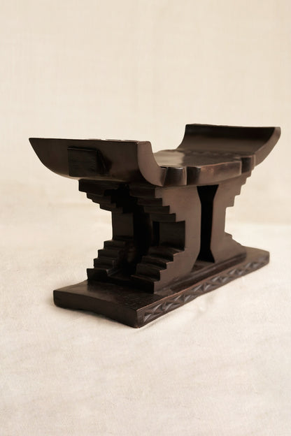 Decorative black Ashanti stool  on a beige background