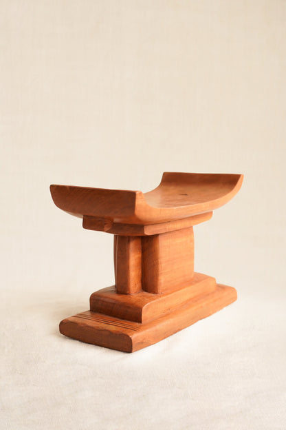 Wooden stool with a minimalist design on a beige background