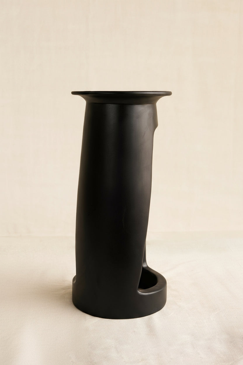 Black cylindrical table  on a beige background