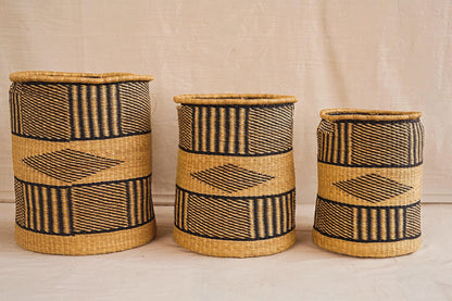 Three handwoven Bolga storage baskets in different sizes with geometric patterns, featuring complimentary linings.