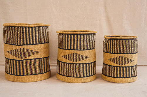 Three handwoven Bolga storage baskets in different sizes with geometric patterns, featuring complimentary linings.