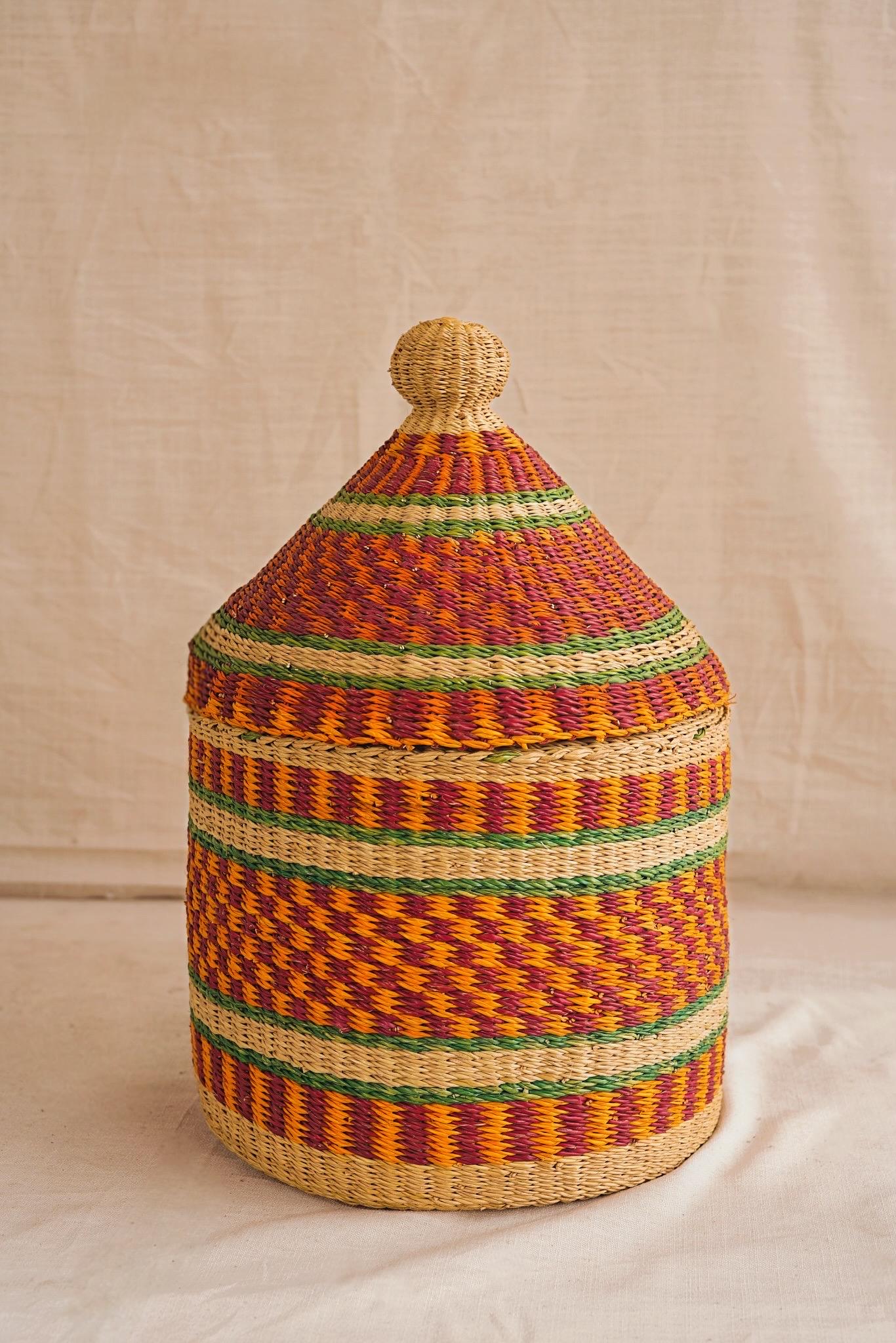 Woven basket with a lid on a neutral background