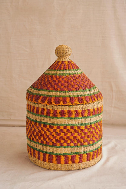 Woven basket with a lid on a neutral background