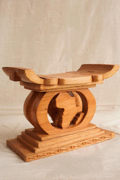 Wooden object with a globe design on a plain background. Map of Africa Ashanti Stool