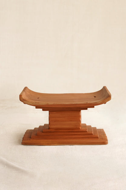 Miniature Ashanti stool with handmade in Ghana on a linen backdrop