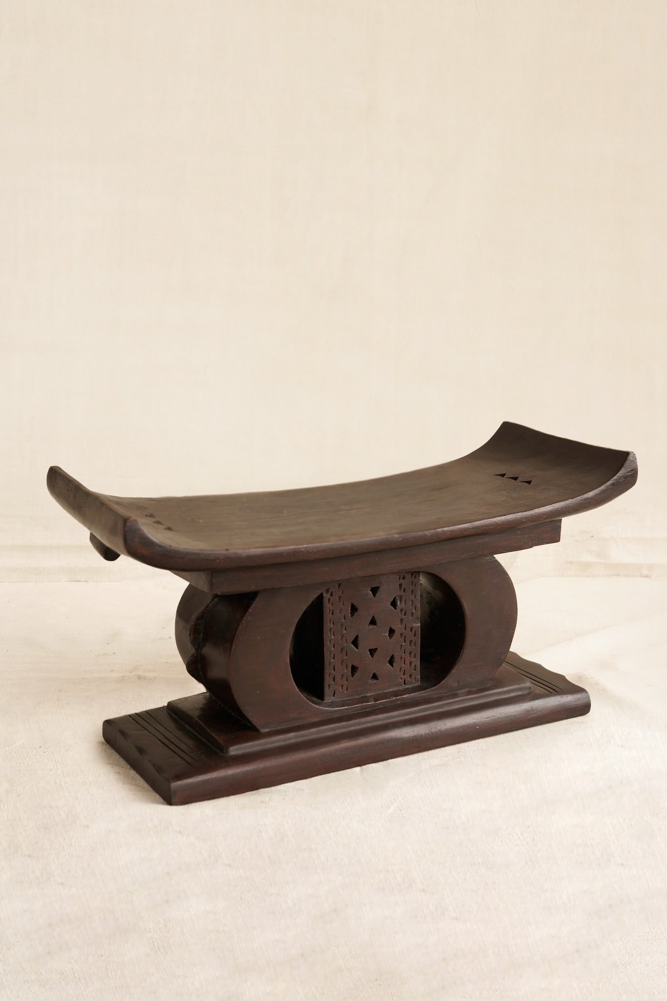 Decorative black Ashanti stool  on a beige background