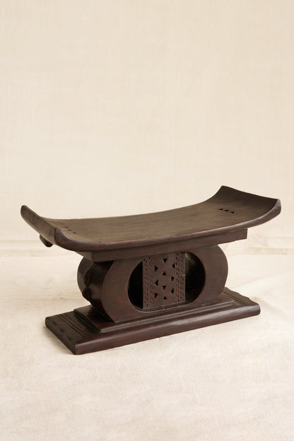 Decorative black Ashanti stool  on a beige background