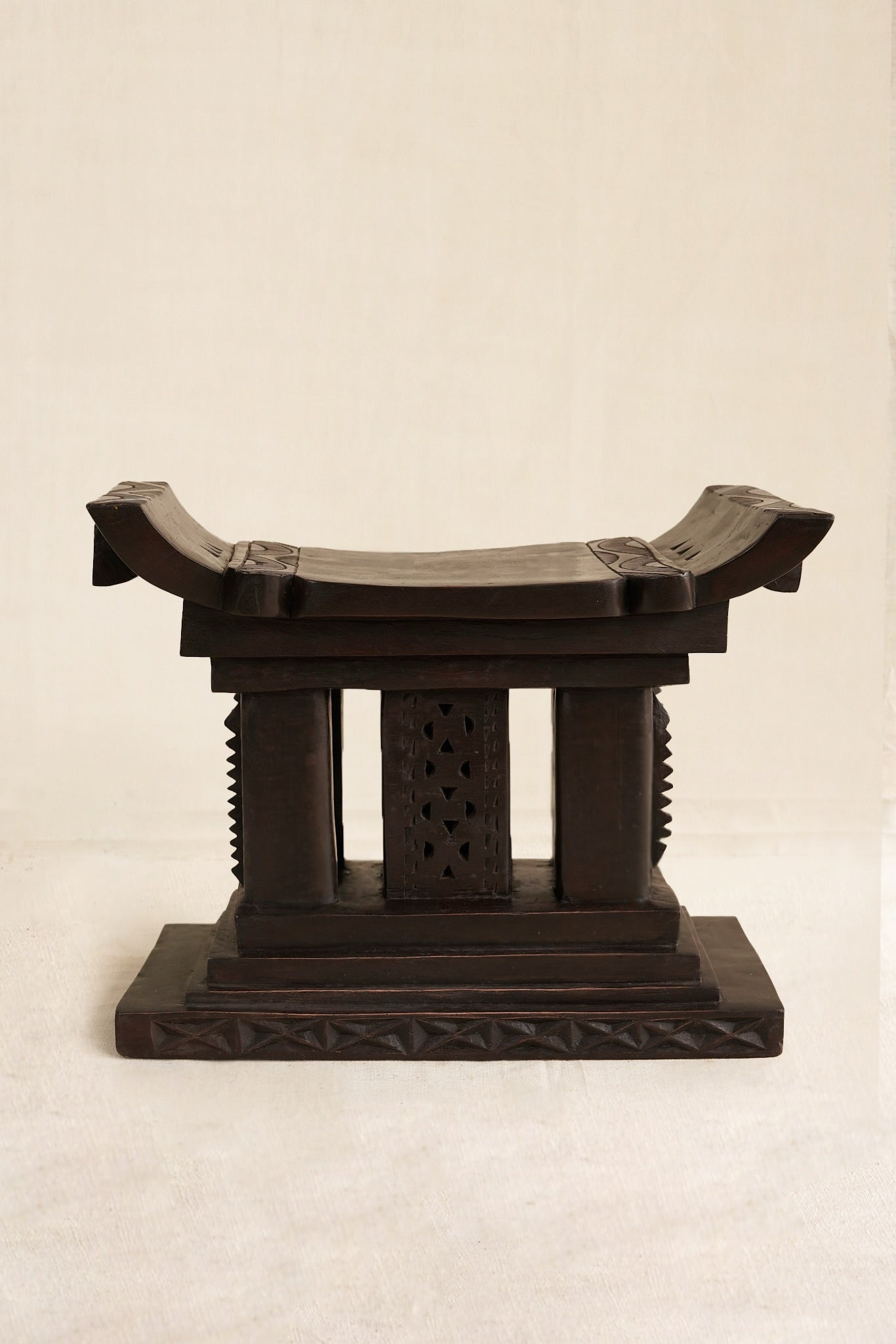 Decorative Black Ashanti stool  on a beige background
