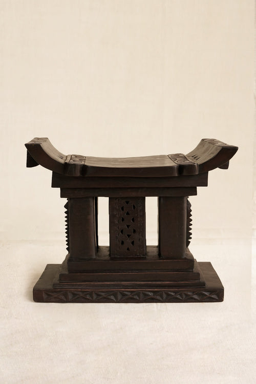 Decorative Black Ashanti stool  on a beige background