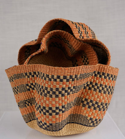 Woven basket with a geometric pattern on a white background