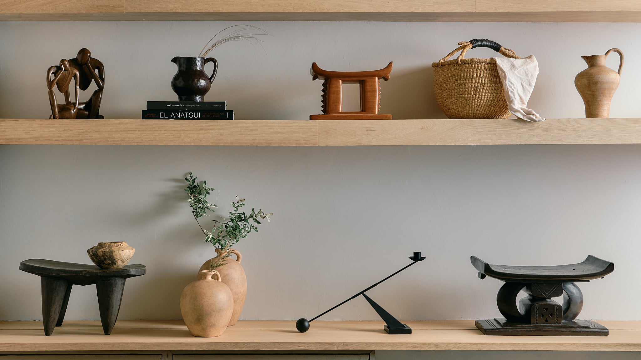 Wooden shelves with various decorative items against a plain wall.