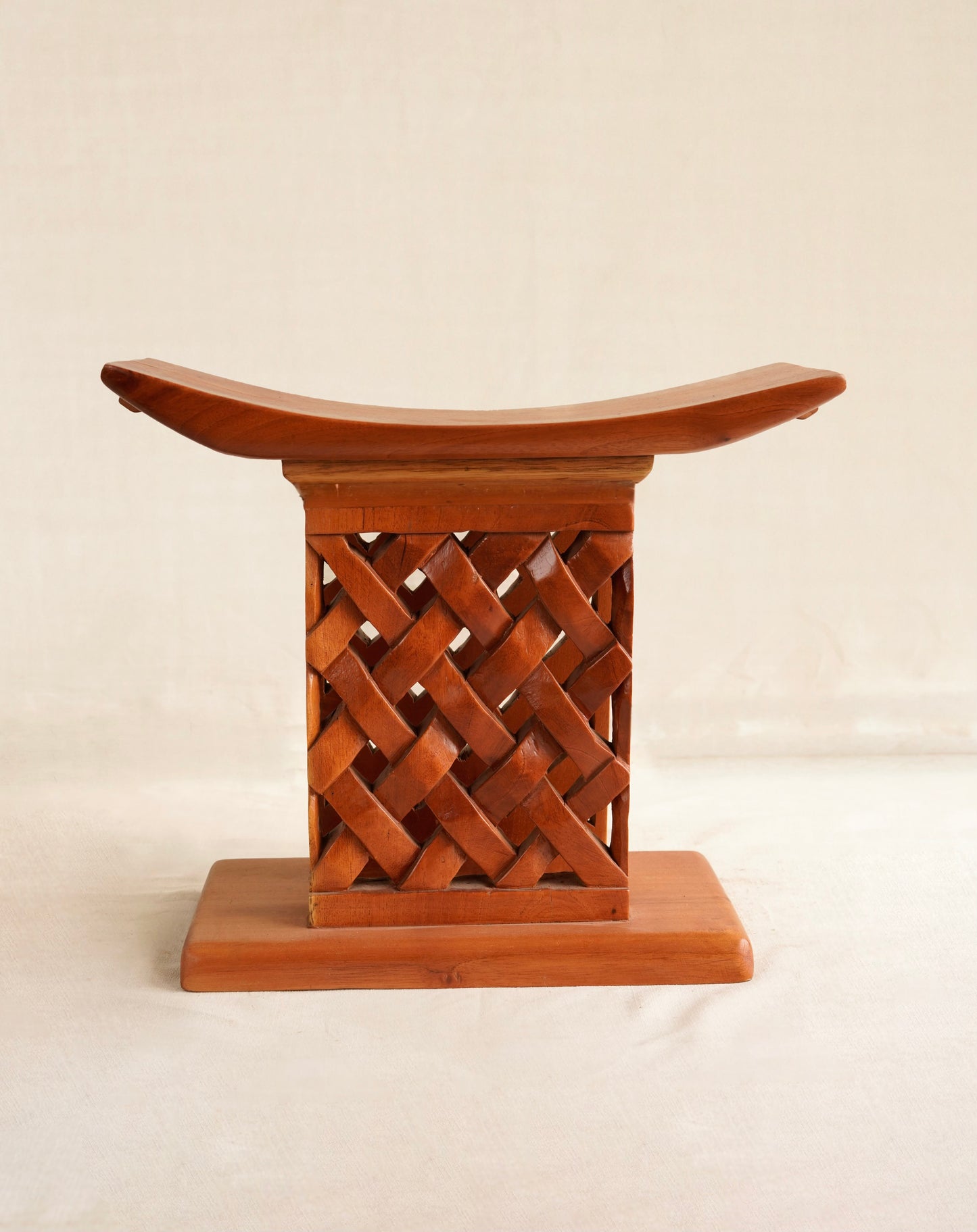 Wooden stool with lattice design on a white background