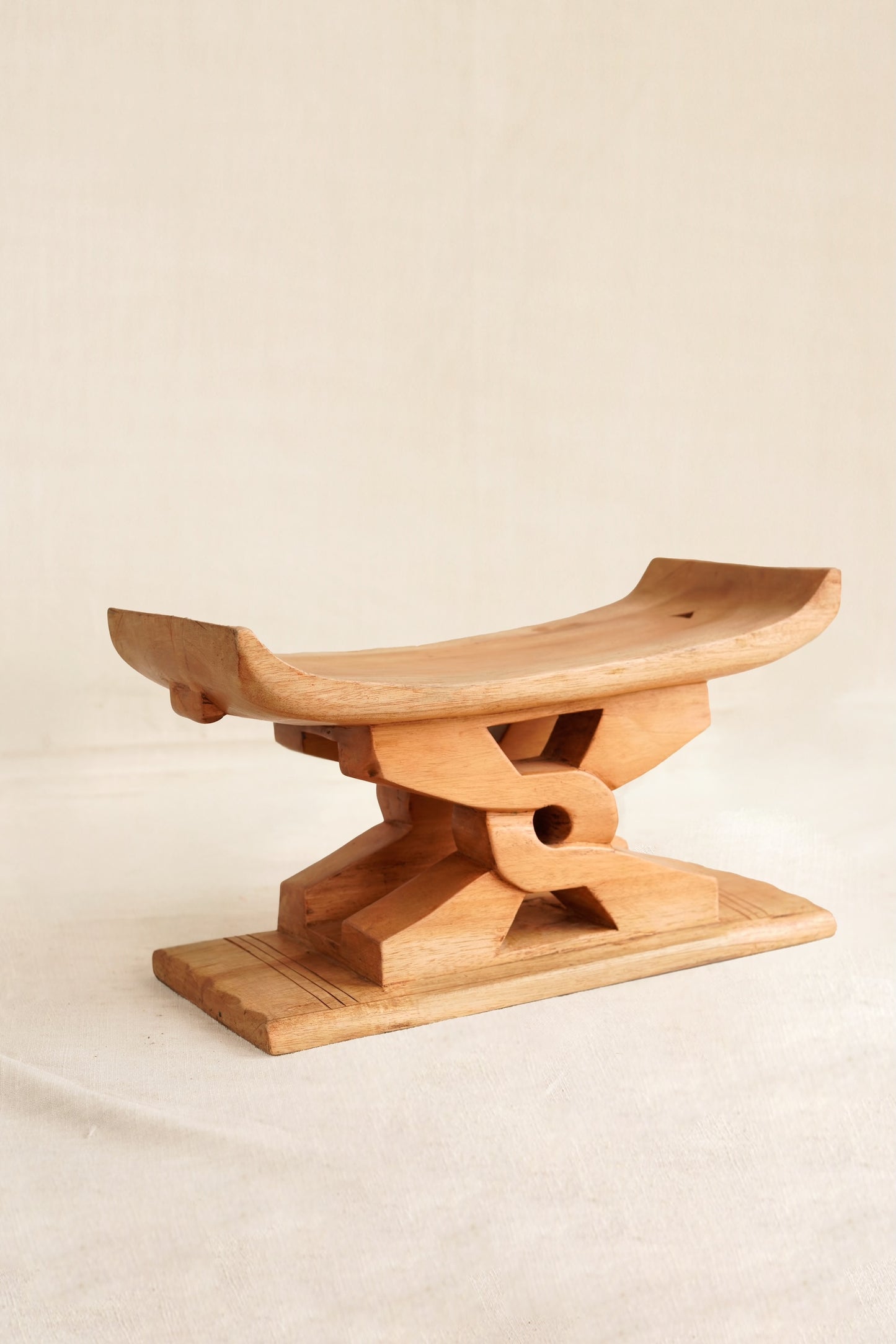 Miniature neutral polished Ashanti stool with Nyansapo Adinkra symbol handmade in Ghana