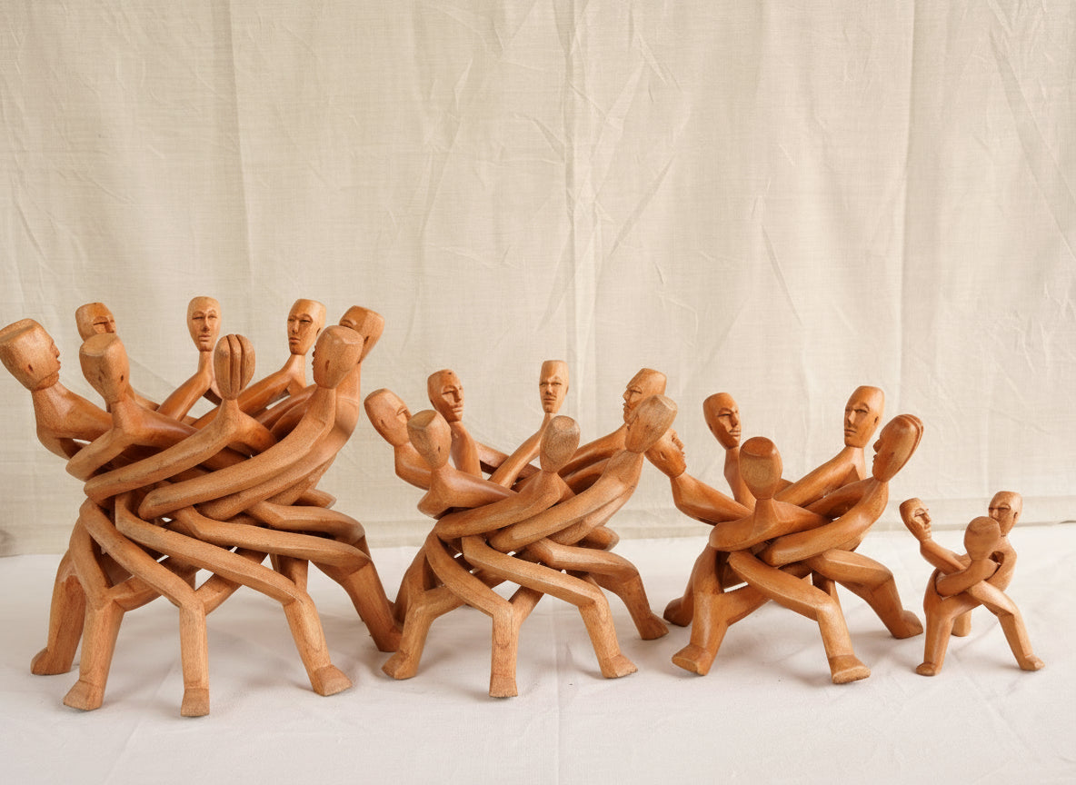 Wooden figurines arranged in a dynamic pose on a plain background